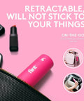 Pink Retractable Mini Lint Roller With 30 Extra Sticky Sheets shown in purse, front view