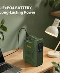 Reliable Portable Power Station 500W featuring LiFePO4 cell connected to a laptop on a wooden desk with lamp.