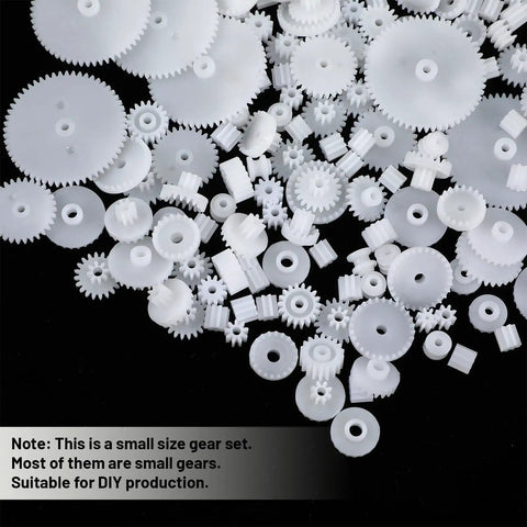 Assorted white gears from 200 Piece Plastic Gear Set Kit For DIYers Working On Models And Toys, small and large sizes visible.