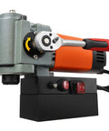 Rock Solid 1300W Portable Magnetic Drill Press With Integrated Cooling, Compact Low Profile Body, Beast Mode 10000N Base showcasing side view with control buttons and grip.