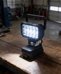 ABS Flood Light 15 LEDs Compatible with 18V Li-Ion Packs on a workbench in a workshop setting.