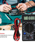 Technician using DT-830B Digital Multimeter With Large LCD Display for circuit testing on workbench, shows amp and volt readings