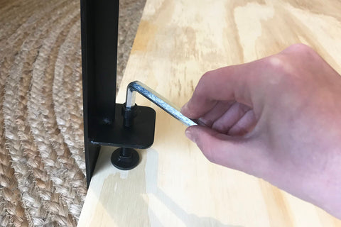 Adjusting a Set Of Four Adjustable Table Clamp Legs For 16 Inch Coffee Tables, Powder Coated Steel Build, Supports Up To 200 Lbs on wood surface