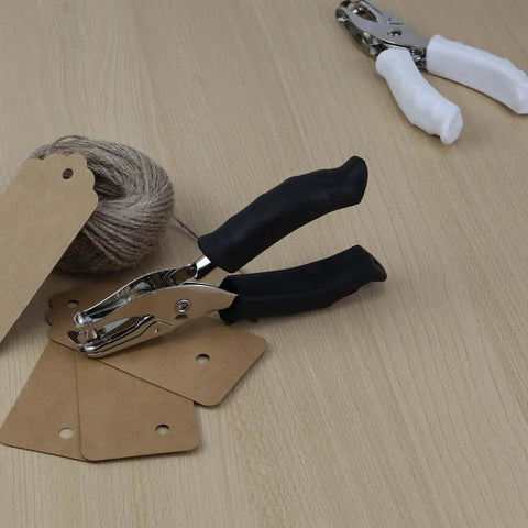 Handheld Circle Hole Puncher One Quarter Inch With Soft Grip Handle for scrapbooking and card making on wooden surface