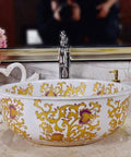Slick White Ceramic Vessel Sink For Above Counter Bathroom Vanity With Top Shelf Glossy Glaze And Dead Simple Cleanup Round Art Bowl Shape Durable Porcelain with gold floral design.