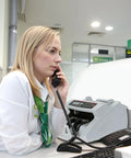 Bank employee with Money Counter Machine With Value Count And Counterfeit Detection UV MG IR Large LCD Display at desk