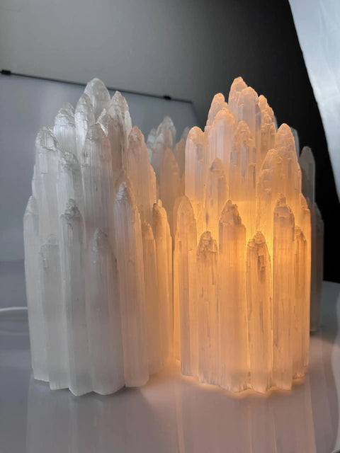 Handcrafted Selenite Lamp With Mountain Peak Design, dimmable bedside night light emitting a warm, white salt crystal glow.