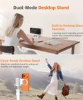 Woman using Magnetic iPhone Camera Grip With Removable Remote And Built In Keychain on desk with tripod setup on phone.