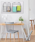 Two Pegboard Baskets Set With Hooks Large 12.4x7.5x12.8 Inches And Medium 11x5x12.6 Inches Includes Four 2 Inch Hooks For Garage Or Workshop Organization Black mounted on a wall with office supplies.