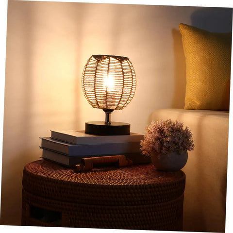 Khaki Rattan Pendant Lamp Shade With Hollow Basket Design for cozy living room ambiance, natural glow with books and plant decor
