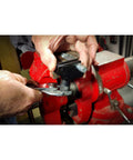 Powerbuilt universal thread repair tool in use; repairing damaged bolt threads in a red bench vise.