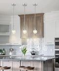 Mini Pendant Light With Dope Teardrop Crystal Jellyfish Pattern, Chrome Finish, 5W LED in kitchen setting with bar stools.