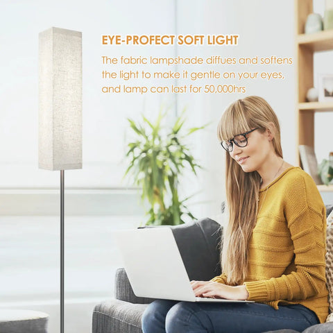Woman using laptop beside Modern Floor Lamp With Remote Control For Bedroom Living Room Office 4 Color Temperature Stepless Dimmer LED Light Bar 11 Inch Tall Standing Lamp With Cozy Ambience 3000K To 7000K.