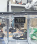 Close-up of a temperature and humidity monitor for 3D printers DIY friendly hygrothermograph kit in a box enclosure.