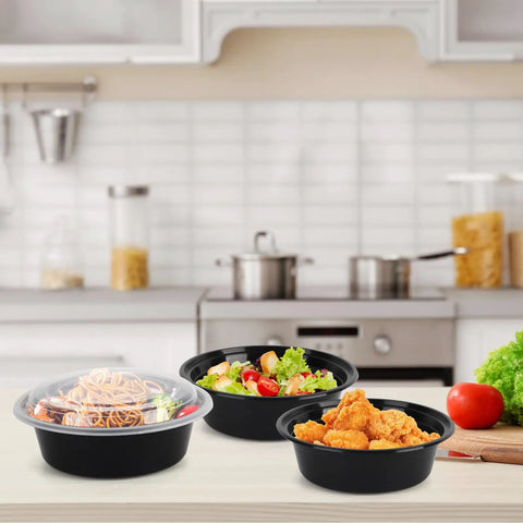 Meal Prep Containers With Lids 50 Pack 32 Ounce Round To Go Food Storage Bowls with salad and pasta in a kitchen setting