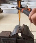 6-Piece Alloy Steel Chisel Set For Concrete Breaking And Stone Carving in use for metal punching in a workshop vise.