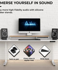 Angled Desktop Speaker Stands With Anti Slip Silicone Wedges for Medium Speakers displayed on a white desk with computer monitor.