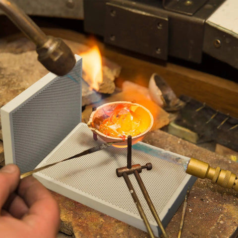 Jeweler using Two Piece Honeycomb Ceramic Soldering Board Set for jewelry making with flame, melting metal in high temp quartz panels