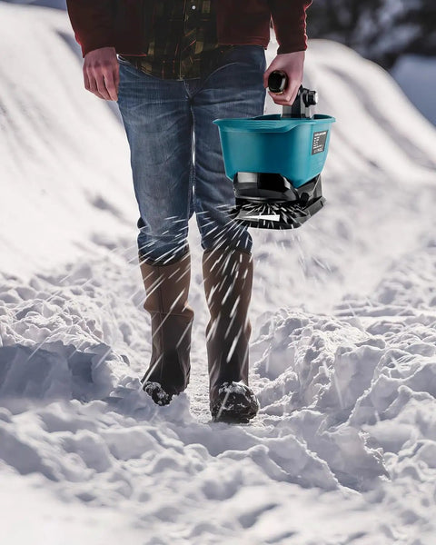 Person using Handheld Seed Spreader For Makita 18V Battery Lawn Fertilizer And Salt Ice Melt Spreader Year Round Use For Grass Seed Fertilizer Rock Salt And Ice Melt Battery Not Included on snowy path