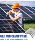 Worker installing solar panels using Bulk 42 Pack Aluminum Solar Panel Mid Clamps For Mounting On Tin Roof Flat Roof And Sheet Roofs.