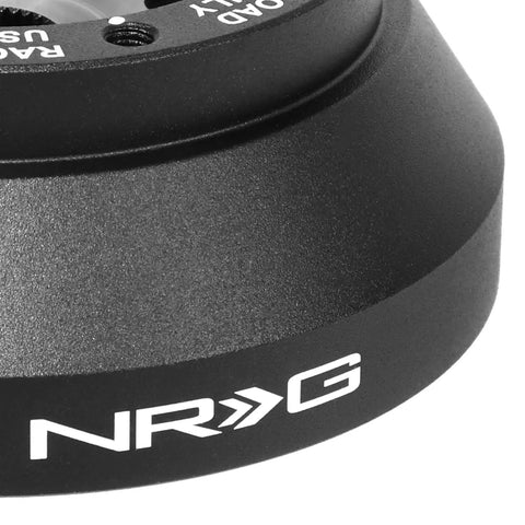 Close-up of Lockable Aluminum Steering Short Hub And Quick Release Adapter Unit With 6x70mm Bolt Pattern in black finish.