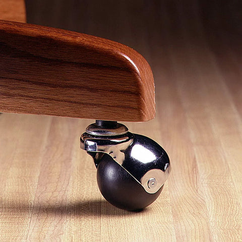 2-Inch Office Chair Caster With Soft Black Rubber Ball, Chrome Hooded Swivel, installed on a wooden furniture leg