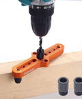 Kaas self-centering dowel jig kit, front view; orange aluminum body with drill bit and knurled 1/4, 5/16, 3/8 in guides.
