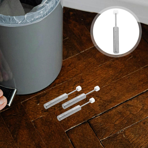 6 Pcs Trash Can Piston Replacement With Soft Close Mechanism Damper displayed near a gray wastebasket on wooden floor