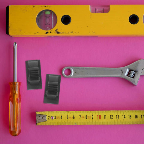 Self Adhesive Pipe Holder Clamps For Filtration System Tubes And Washing Machine Hoses, Black Plastic Tube Clips With Soft Cushioned Inner Lining, Multi Line Organizer For Water Tubing And Electrical Wires, Great For Renovation Or Appliance Setup, shown with tools and ruler