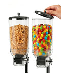 Level Up Your Kitchen Game With This Heavy Duty Dual Chute Cereal Dispenser keeping dry goods and snacks in clear jars.