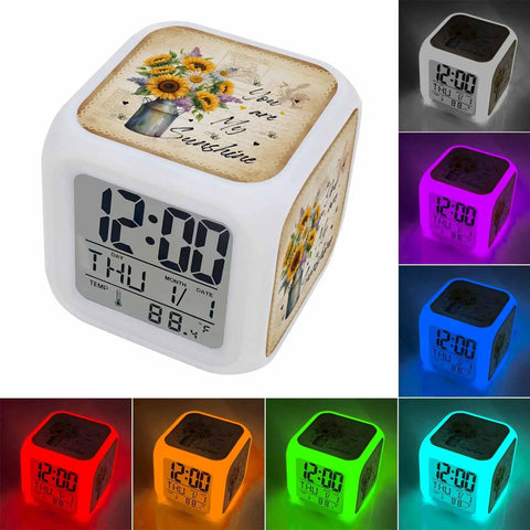 Slick Farmhouse Sunflower Bee Cube Digital Alarm Clock showing time, date, and temperature with color-changing nightlight feature.