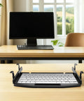 Ergonomic Under Desk Keyboard Tray With Slick Slide Out Gliding Platform And Contoured Wrist Support Plus Hidden Cable Routing For Serious Typing Comfort And A Neat Workspace Setup on a wooden desk.
