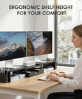 Woman using dual monitor stand riser with drawer and pen holders, metal desk organizer for office, computer shelf and racks, black