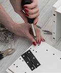 Installing Black Stainless Steel Small Folding Cabinet Door Hinges With Screws on a white wooden board