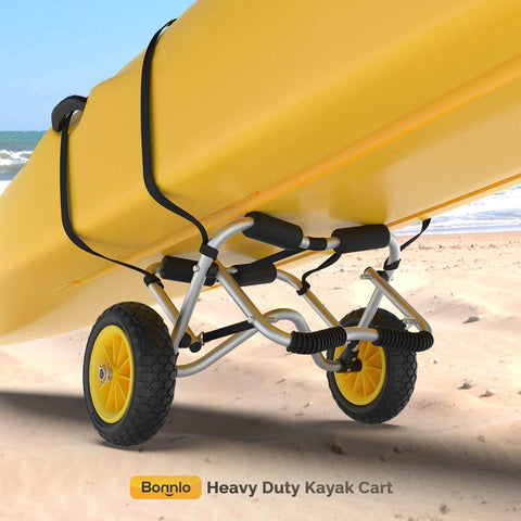 Go-To Universal Kayak Carrier Trolley showing anodized aluminum frame, solid airless tires, and kayak support straps on beach