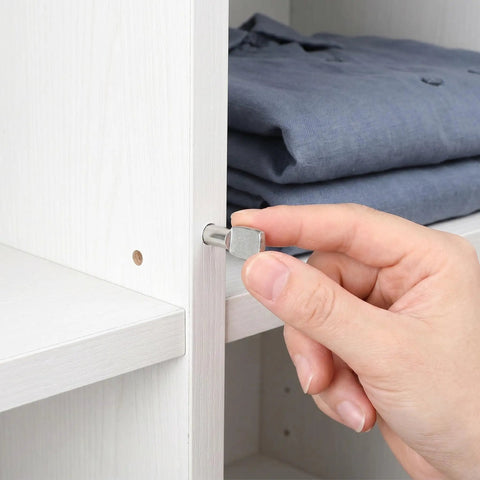 Hand inserting Beefy Spoon Shape Metal Shelf Pegs 60 Pack 7mm Nickel Plated Shelf Pins for kitchen cabinets and closets