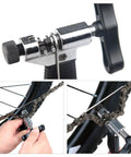 Oumers bike chain tool with chrome body and black handle; for breaking and installing bicycle chains on road or mountain bikes.