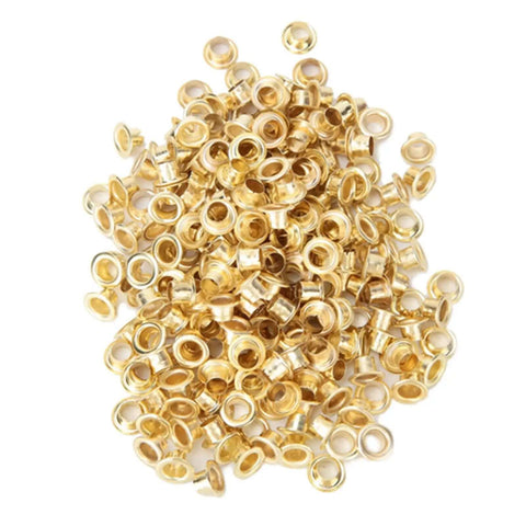 Heap of gold metal grommets from Pro Grade Grommet Tool Kit for Tarps, Fabric, and Leather, Heavy Duty Metal Retainer Kit