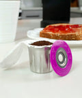 Stainless Steel Reusable K Cup For Keurig 1 Stream Coffee Pod With 25 Paper Filters on kitchen counter next to toast