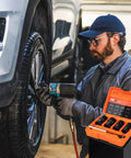 Mechanic using Lug Nut Removal Kit With Six Piece Extractor Set One Half Inch Drive Locking Lug Nut Removers For Damaged Frozen Rounded Off Bolts And Nuts Rusted Studs And Screws Heavy Duty Wheel Repair Like A Pro on a car wheel.