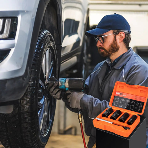 Mechanic using Lug Nut Removal Kit With Six Piece Extractor Set One Half Inch Drive Locking Lug Nut Removers For Damaged Frozen Rounded Off Bolts And Nuts Rusted Studs And Screws Heavy Duty Wheel Repair Like A Pro on a car wheel.