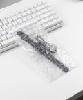 Self Adhesive Bubble Packaging Bags For Shipping Fragile Items 100 Count Pro Grade PE Material Flat Pouches on white desk