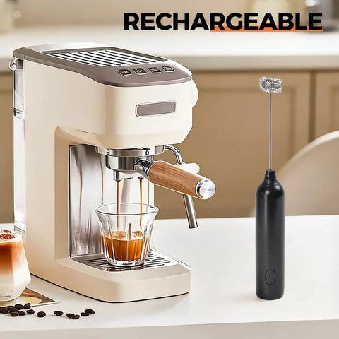 Rechargeable Handheld Milk Frother With USB Type C 3 Speed Adjustable Foam Maker next to an espresso machine