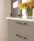 Drawer with Mergence Cabinet Pull in Matte Black Champagne Bronze, Five And One Sixteenth Inch Center To Center, installed in kitchen
