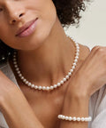 Model wearing Japanese Akoya Pearl Pendant Necklace For Women, 8.5-9mm White Cultured Pearl AA+ Grade, 14K Yellow Gold, 18 Inch Chain.