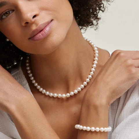 Model wearing Japanese Akoya Pearl Pendant Necklace For Women, 8.5-9mm White Cultured Pearl AA+ Grade, 14K Yellow Gold, 18 Inch Chain.