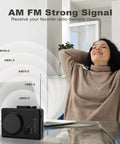 Portable Cassette Player And Tape Recorder With Cassette To MP3 Converter, AM FM Radio next to a relaxed woman at home.
