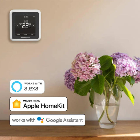 T5 WiFi Smart Thermostat With 7 Day Programmable Touchscreen Alexa Ready Geofencing Technology on wall above flowers