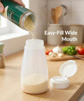 Top Shelf Soft Parmesan Cheese Shaker Set Squeezable Spice Jars With Wide Opening Heavy Duty Plastic Seasoning Dispensers pouring cheese.