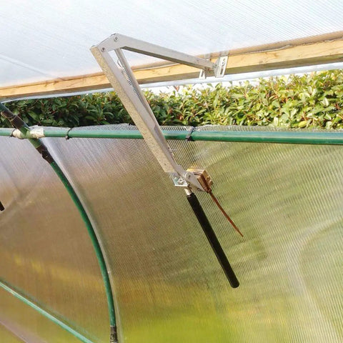 Solar Powered Greenhouse Vent Opener Kit Auto Open Close For Wooden And Aluminum Greenhouses With Temperature Activated Action High Lift Up To 7kg Rust Resistant Aluminum Stainless Steel Construction inside a greenhouse.